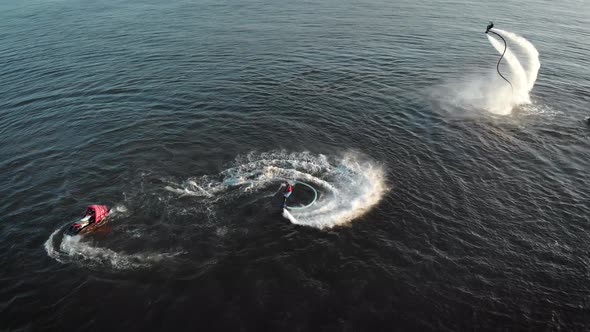 Two Men Are Using Flyboards in Summer Time, Flying Over Surface of Lake, Aerial View, Water Scooters