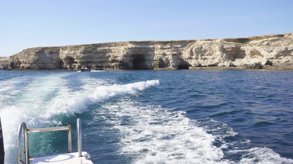 Motor Boat Goes Fast on the Sea and Creates Big Splashes Waves Over the Surface of the Water