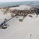 Aerial View of Small Village in Countryside with Snowy Fields Around in Sunshine - VideoHive Item for Sale