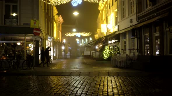 Couple walking in street at night