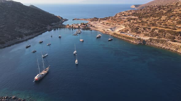 Yachts and sailing boats in bay with a turquoise and transparent sea