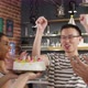 Asian birthday man puffing out cake candles - VideoHive Item for Sale