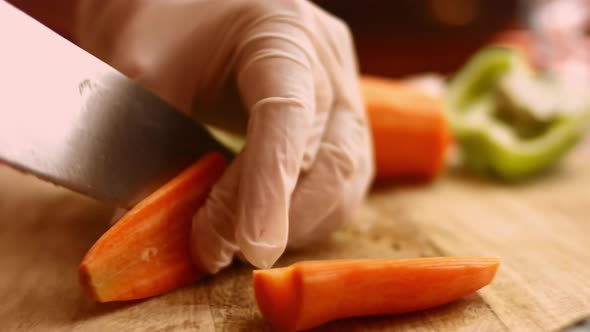 Chef Cuts Carrots for Salad with a Sharp Knife