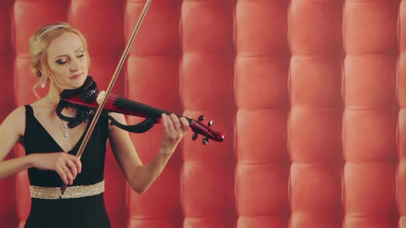 Woman in Black Dress with Violin on Red Background