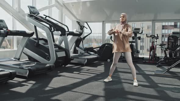 Woman in Hijab Training in Gym