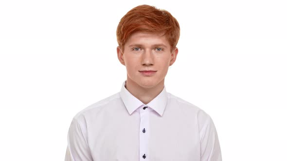 Handsome Young Ginger Caucasian Man Standing on White Background and Smiling