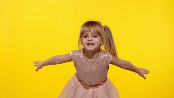 Little Blonde Child Girl 5-6 Years Old Flying, Dancing, Celebrating on Yellow Studio Background