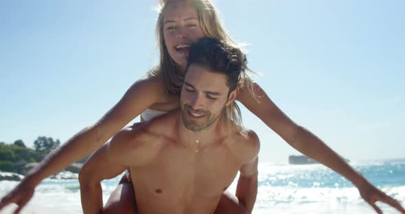 Boyfriend giving piggy back to girlfriend