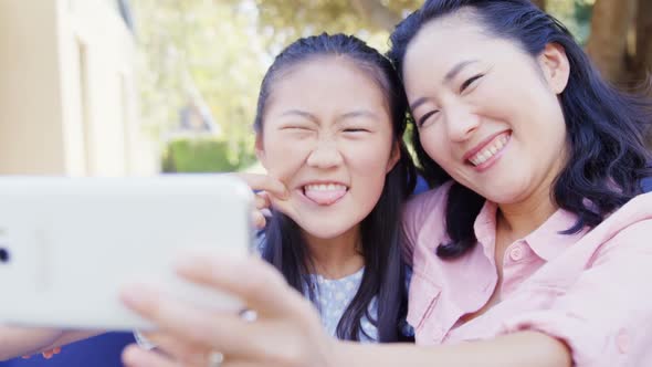 Daughter and mother taking selfie with mobile phone 4k