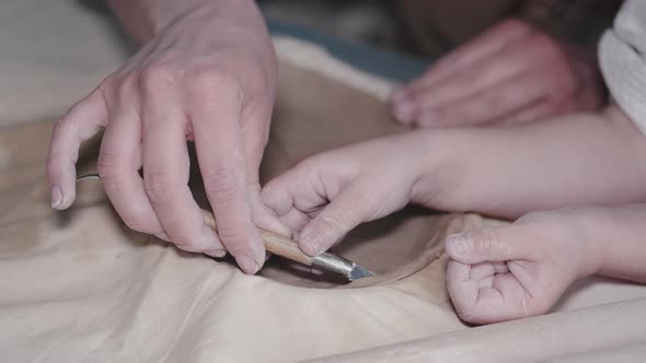 Craftsman Hands Connect the Clay Parts Made of Raw Clay