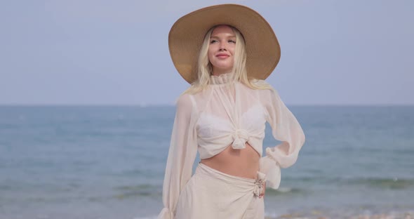 Woman in Elegant Beach Outfit Outdoors Against Sea Background During Summer Vacations