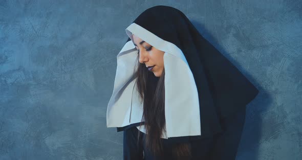 Portrait of a Bad and Sexy Nun Posing at the Camera