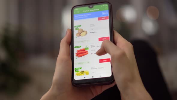 A Woman Orders Food at Home in an Online Store Using Her Smartphone