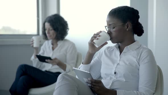 Serious Businesswomen with Digital Tablets