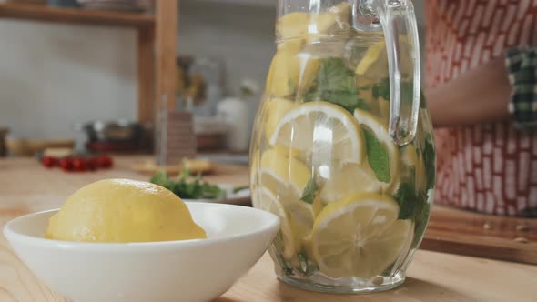 Stirring Homemade Lemonade in Jug