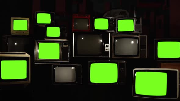 Stacked Retro TVs turning On Green Screens with Static Noise.