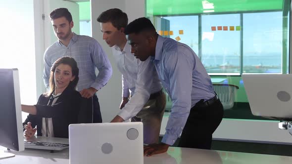 Business colleagues discussing over personal computer 4k