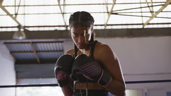 Mixed race woman with boxing gloves