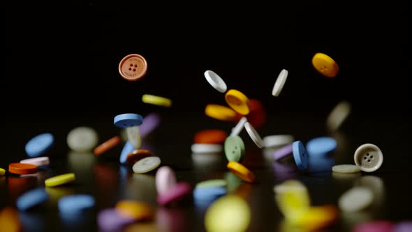 Colorful buttons falling, Ultra Slow Motion alt