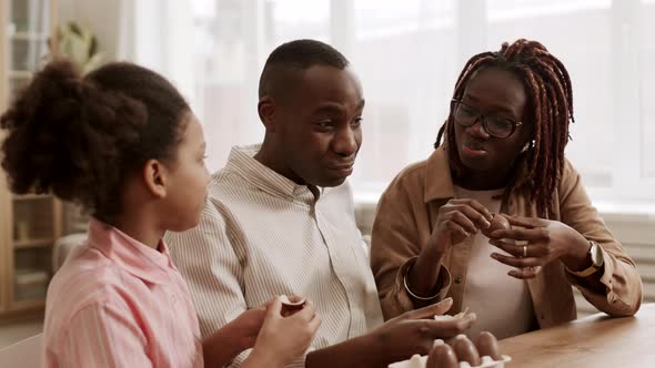 Happy Family Eating Chocolate Eggs