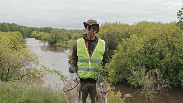 Gardener by River in Forest