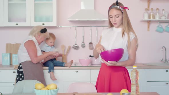 Beautiful Caucasian Young Woman Cooking Lunch for Family in Kitchen. Portrait of Charming Mother in