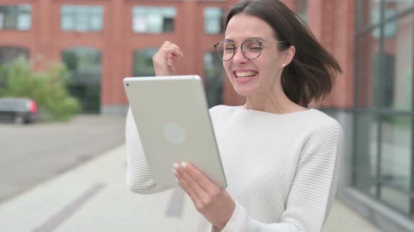 Woman Celebrating on Tablet, Outdoor