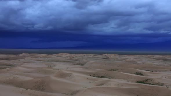 Sand Dunes with Storm Clouds in Gobi Desert