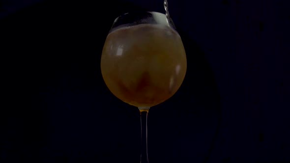 A Sparkling and Bubbly Alcoholic Cocktail Drink Being Mix with a Mixing Spoon.