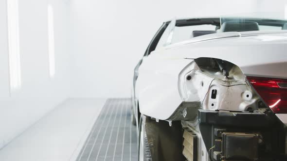 Destroyed car standing in a township workshop being prepared to be repaired