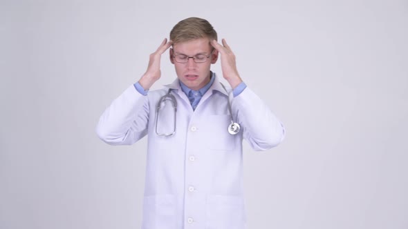 Stressed Young Man Doctor Having Headache