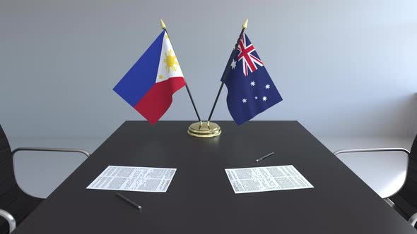 Flags of the Philippines and Australia and Papers on the Table