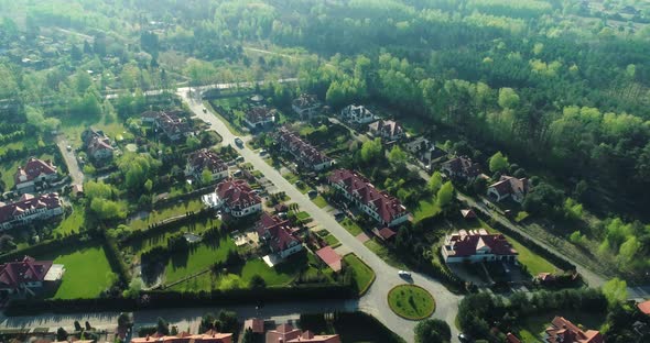 Aerial view of a housing estate in the suburbs surrounded by forest.