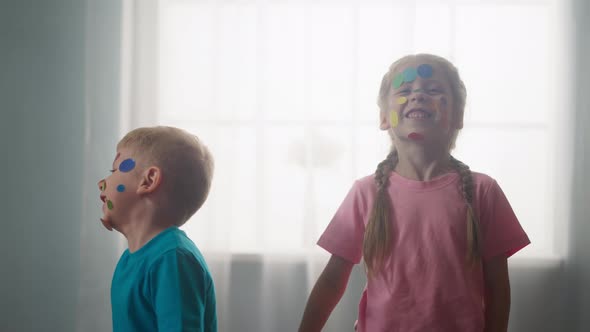 Little Children with Colorful Stickers on Their Faces Express Joy