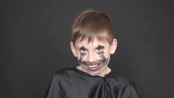 a child in a black carnival costume on a Halloween holiday. a caucasian boy of 7-8 years old in a zo