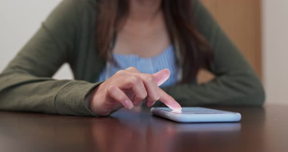 Woman use of mobile phone at home