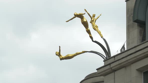 Golden gymnasts statues on a building