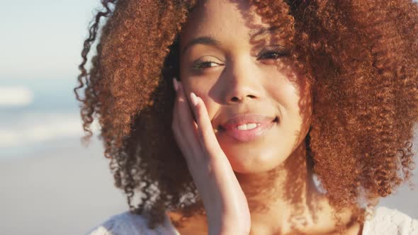 Portrait of African American woman smiling at beach