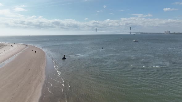 An aerial view of Gravesend Bay in Brooklyn, NY. The drone camera dolly out from the Verazzano Bridg