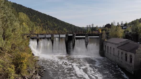 Hydroelectric Dam with Flowing Water Through Gate Aerial View From Drone