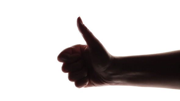 Silhouette Of A Woman's Hand Giving Thumb Up 