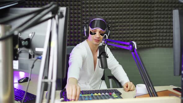 Funny Radio Dj in Sleep Mask and Cosmetic Patches on Broadcast