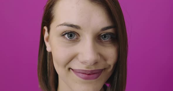 Positive Woman Smiling Over Pink Backgorund