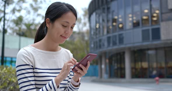 Woman use of mobile phone in city