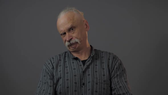 Displeased Old Man Shakes Head Negatively Raising Eyebrow