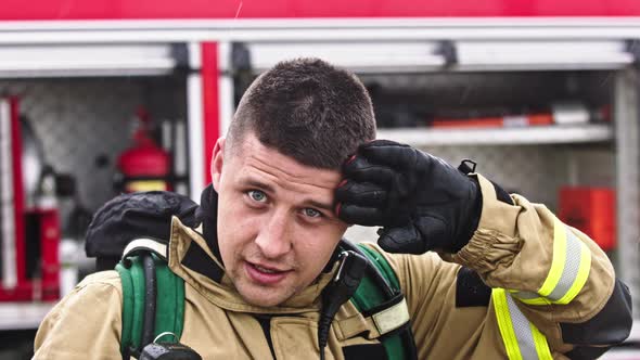 Portrait Shot of Fireman in Front of the Fire Truck