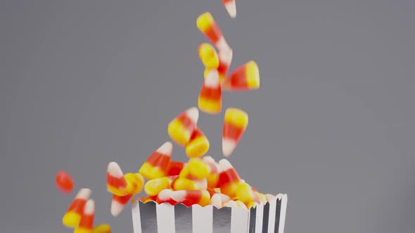 Time for Halloween. Delicious candy corn falls in slow motion.