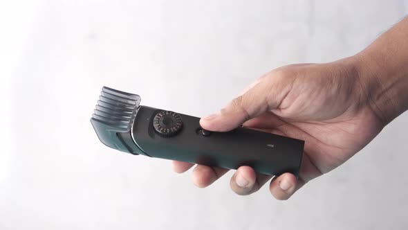 Holding a Hairclipper on White Background