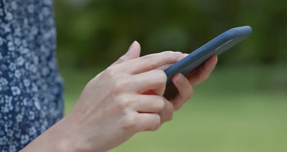 Woman use of smart phone in the park