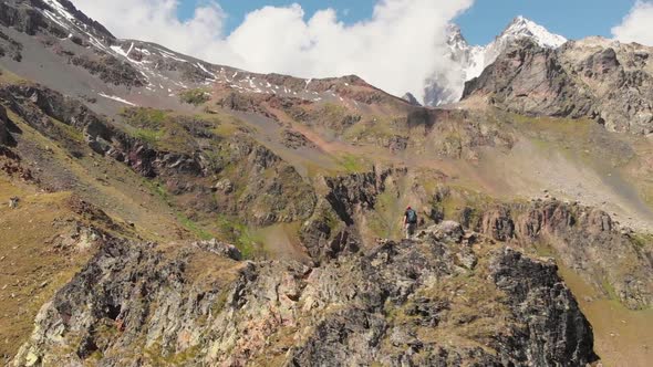 Woman with Backpack Hiking on Mountain Ridge in Caucasus Mountains Georgia